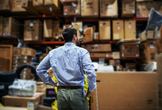 Image of a person in a 3PL warehouse for Newl 3rd party warehouse service & ocean freight shipping company.