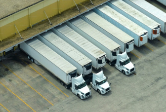 Images of trucks lined up showing Newl ocean freight forwarding service & 3rd party warehouse service.